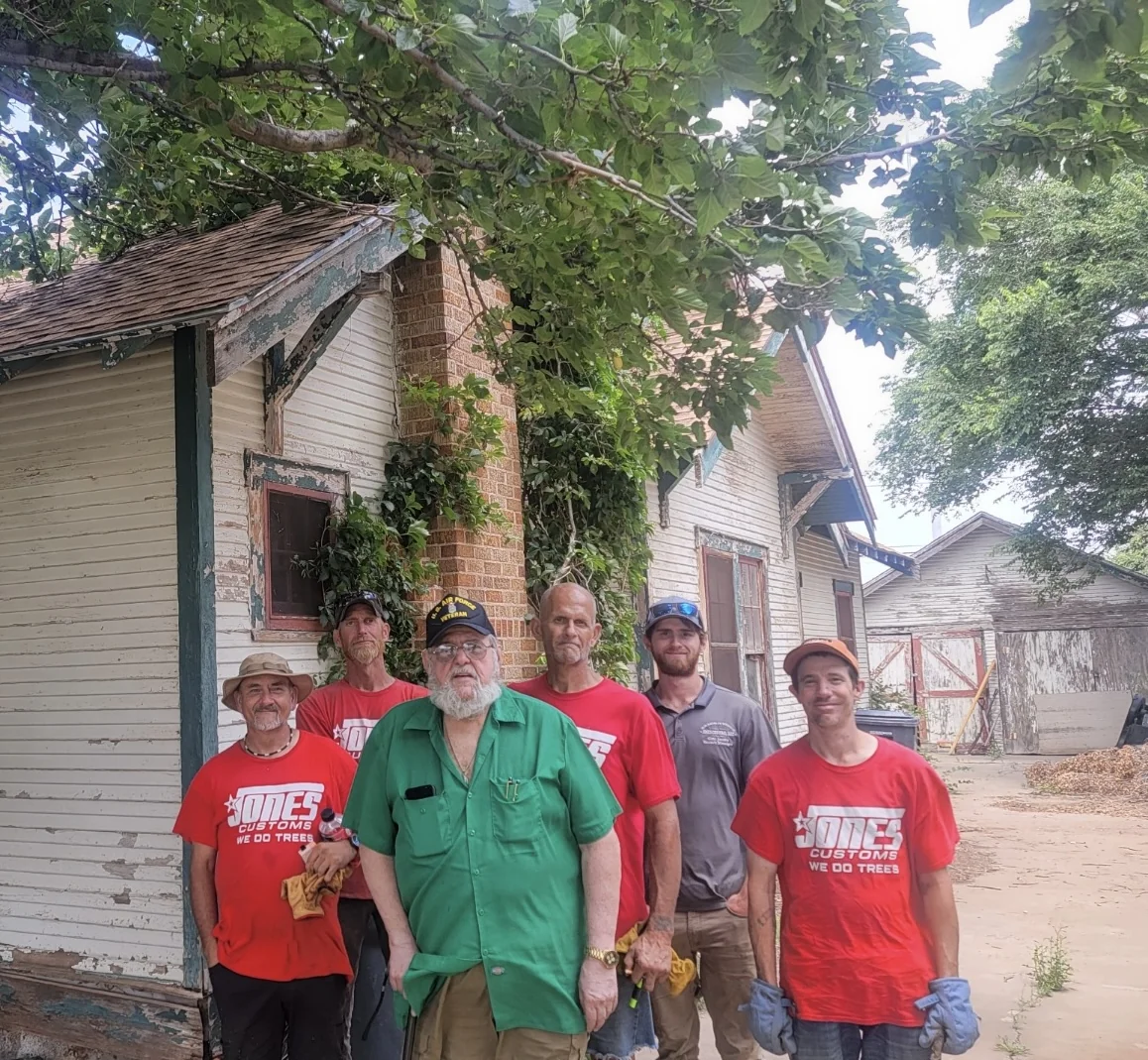 Three members of the community standing together outdoors