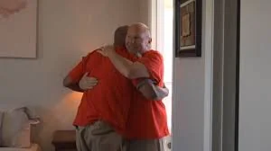 A man receiving the keys to a furnished home in local news coverage